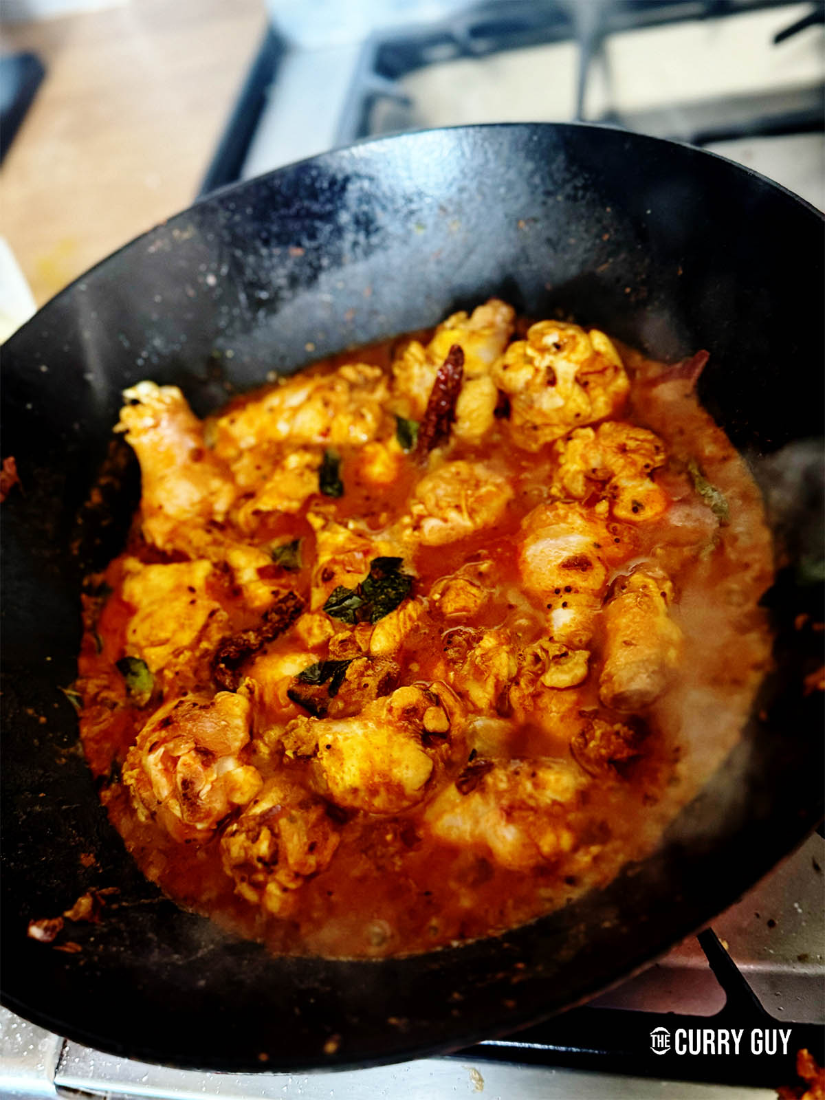 Adding just enough water to cover and cook the chicken.