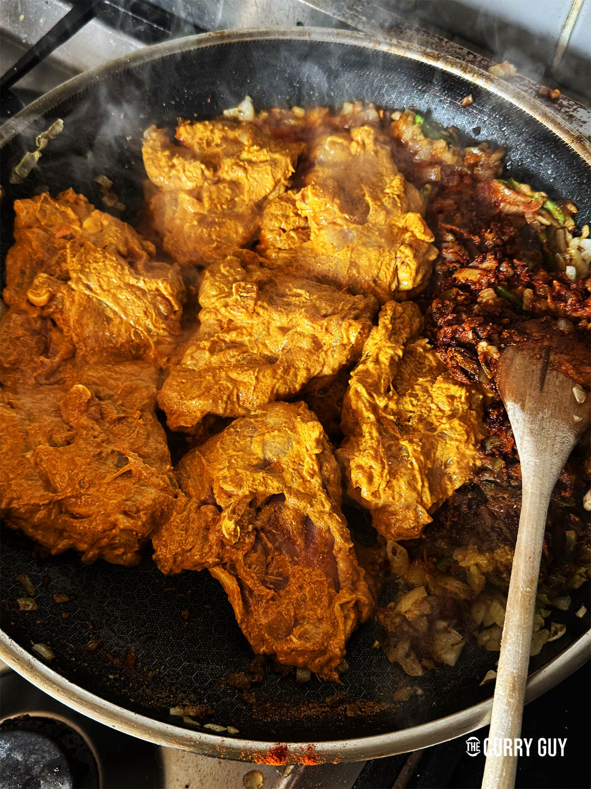 Adding the marinated chicken to the pan to brown it some. 