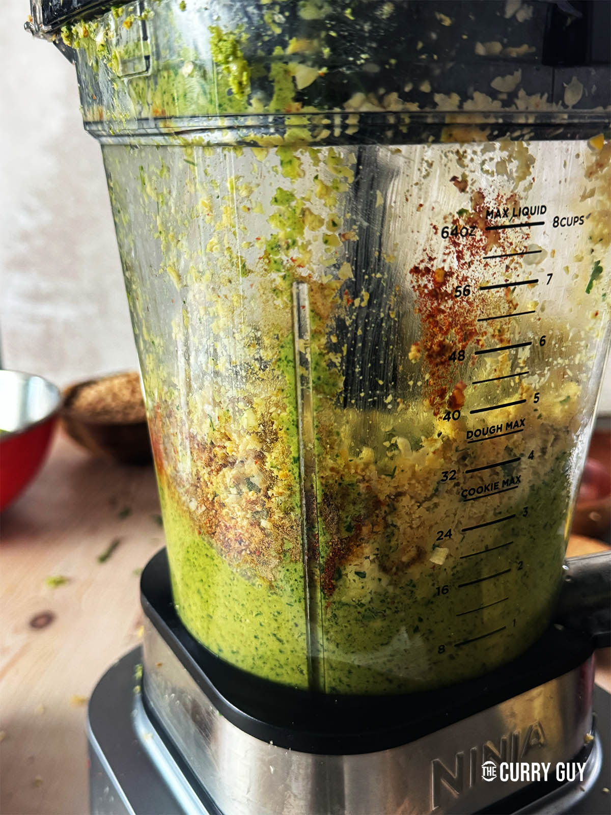 Blending all of the ingredients for the felafel in a blender except for the sesame seeds.
