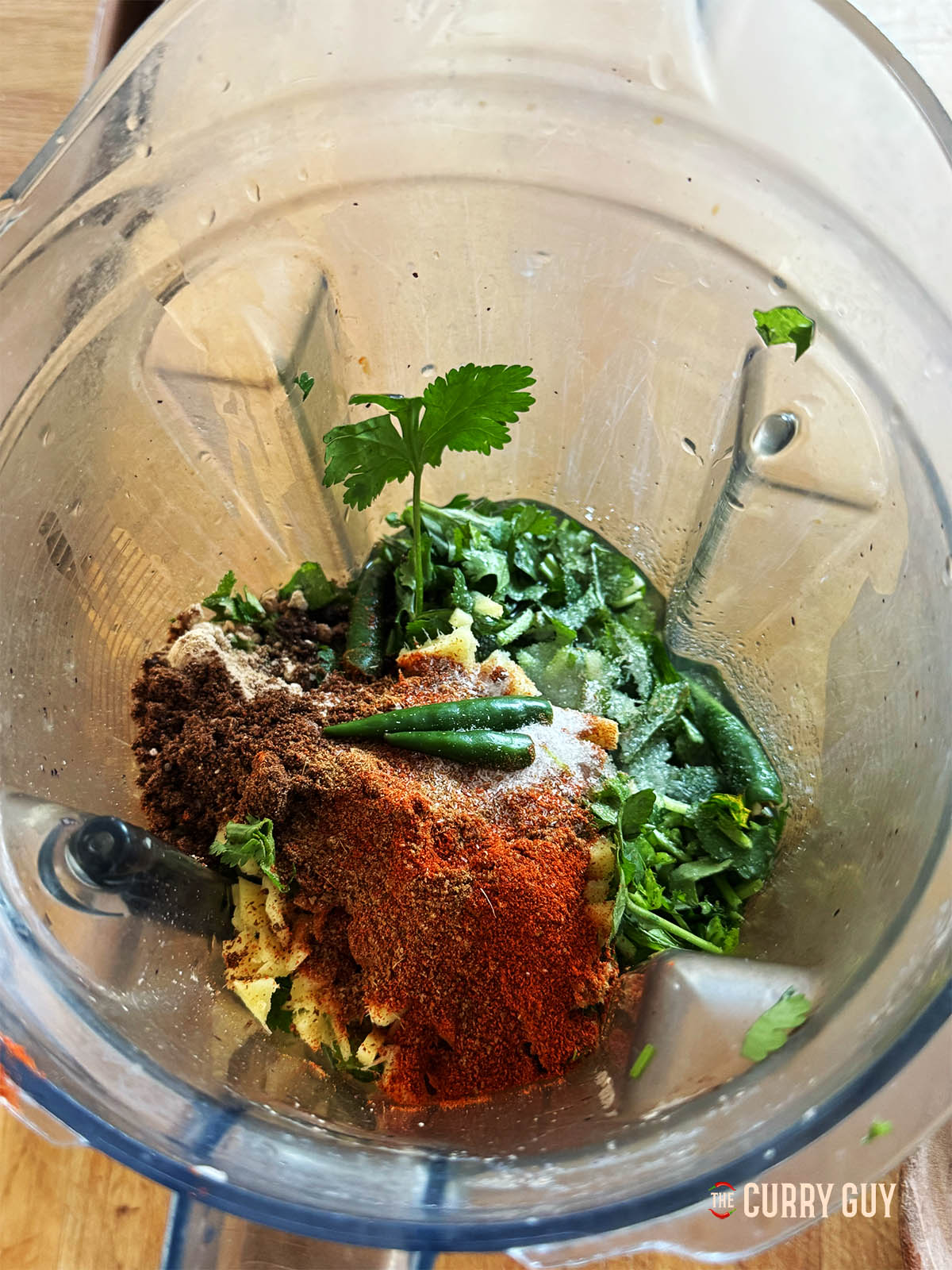 Placing the ingredients for the green pani in a blender.