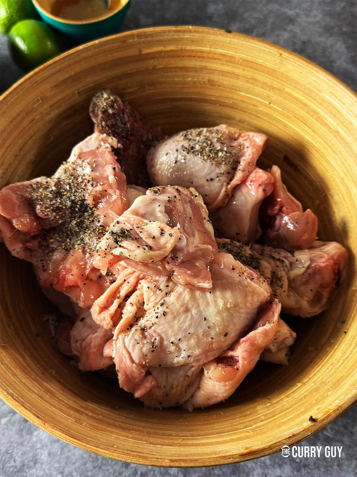 Marinating the chicken with salt, pepper and lemon juice.