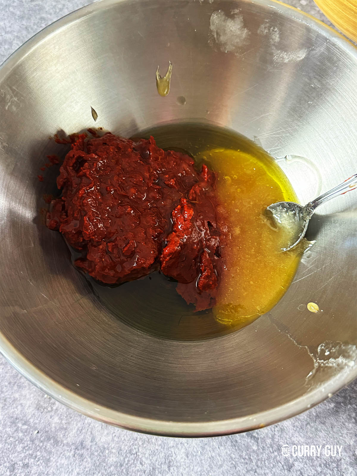 Whisking the harissa, olive oil and honey together.