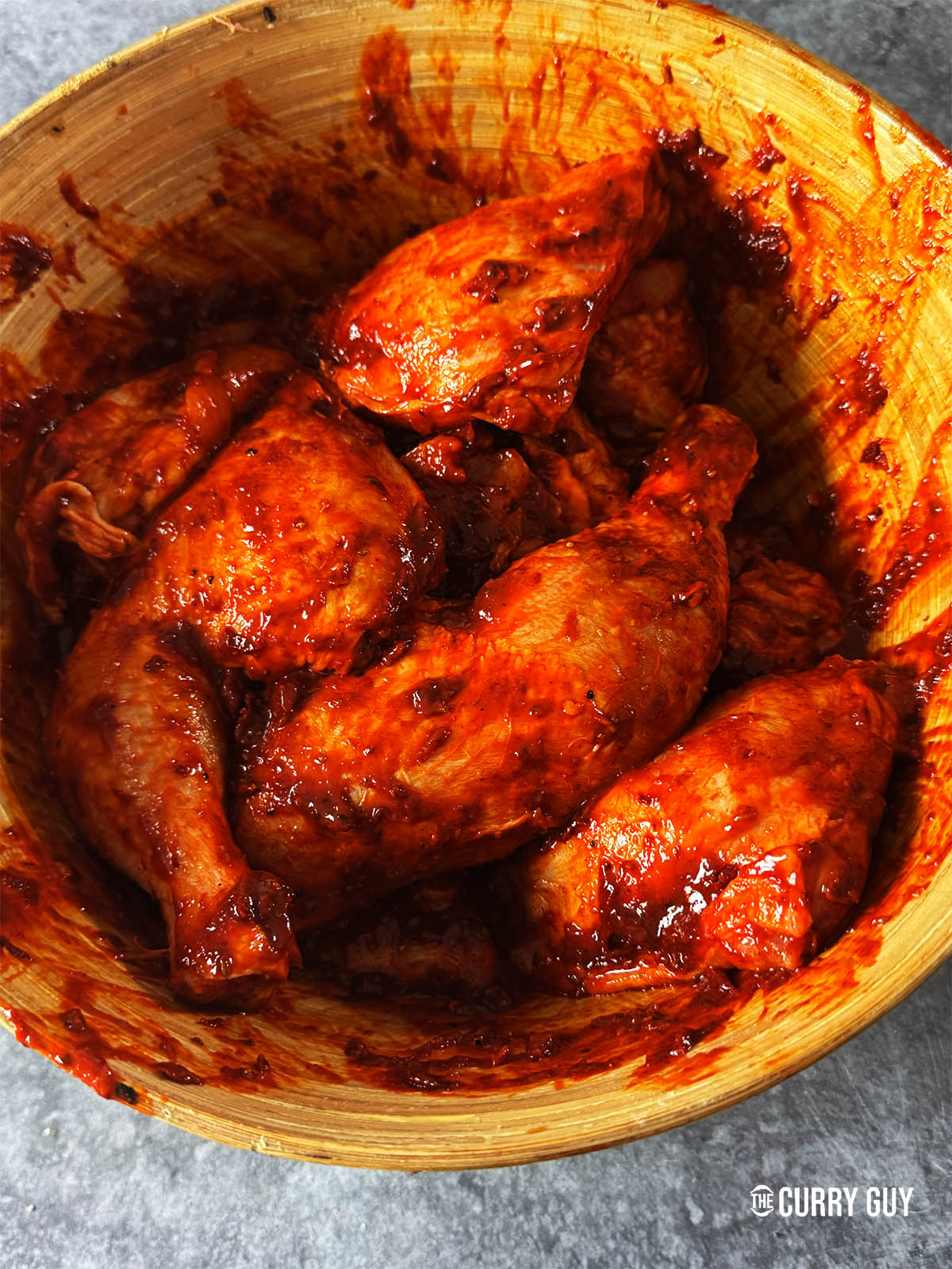 Rubbing the marinade right into the chicken.