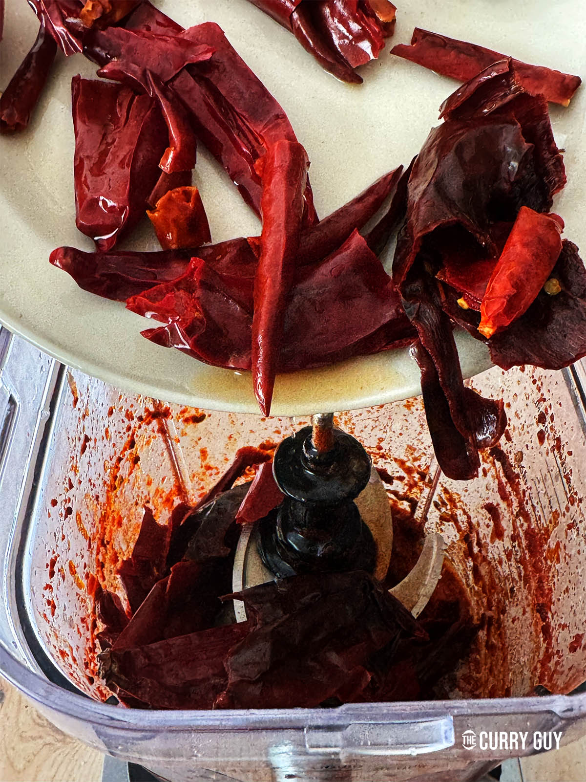 Adding the soaked chillies to the blender.