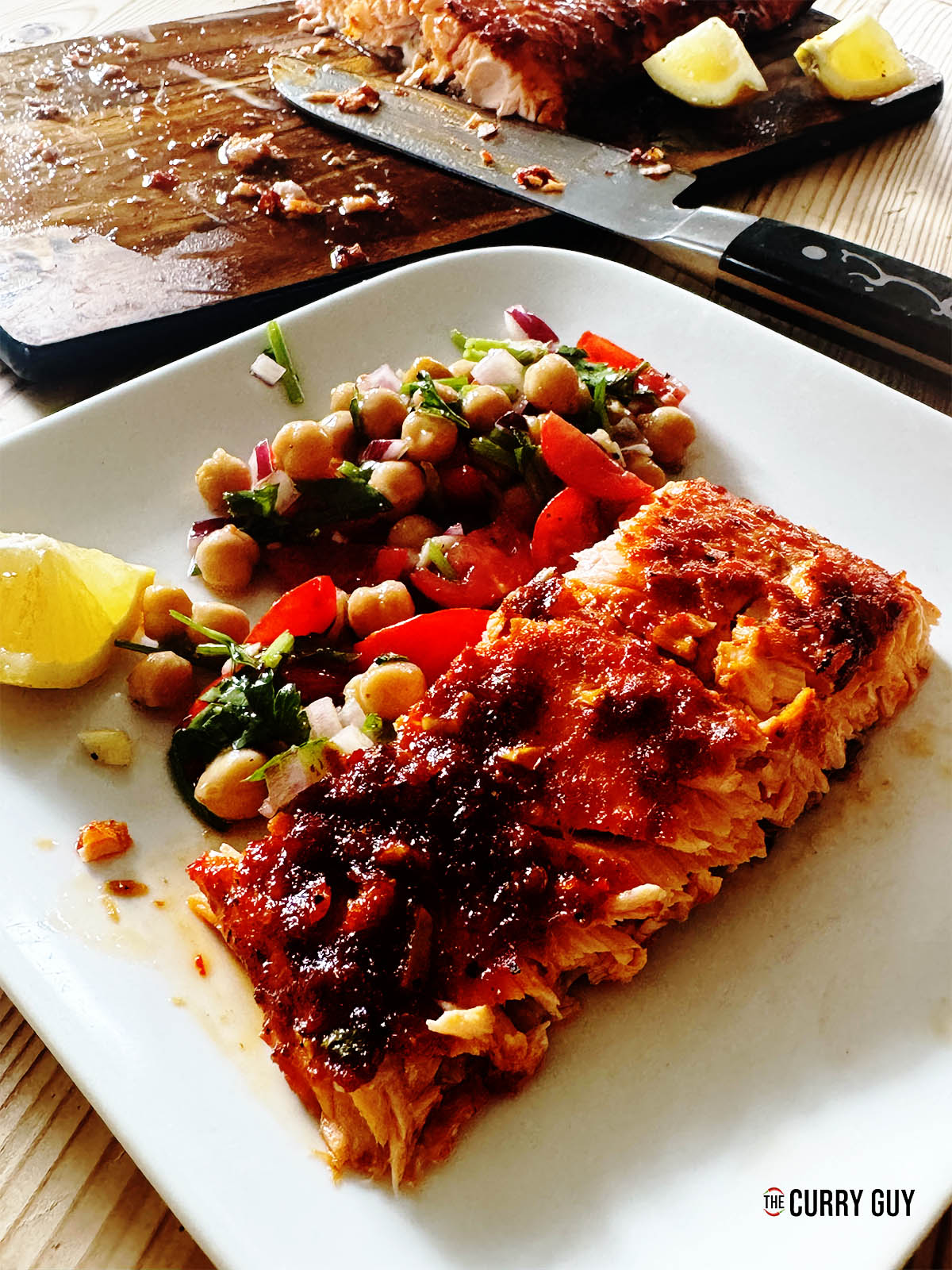 Harissa salmon on a serving plate with side salad