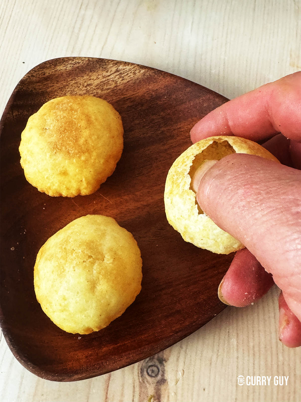 Cracking open one of the puris.