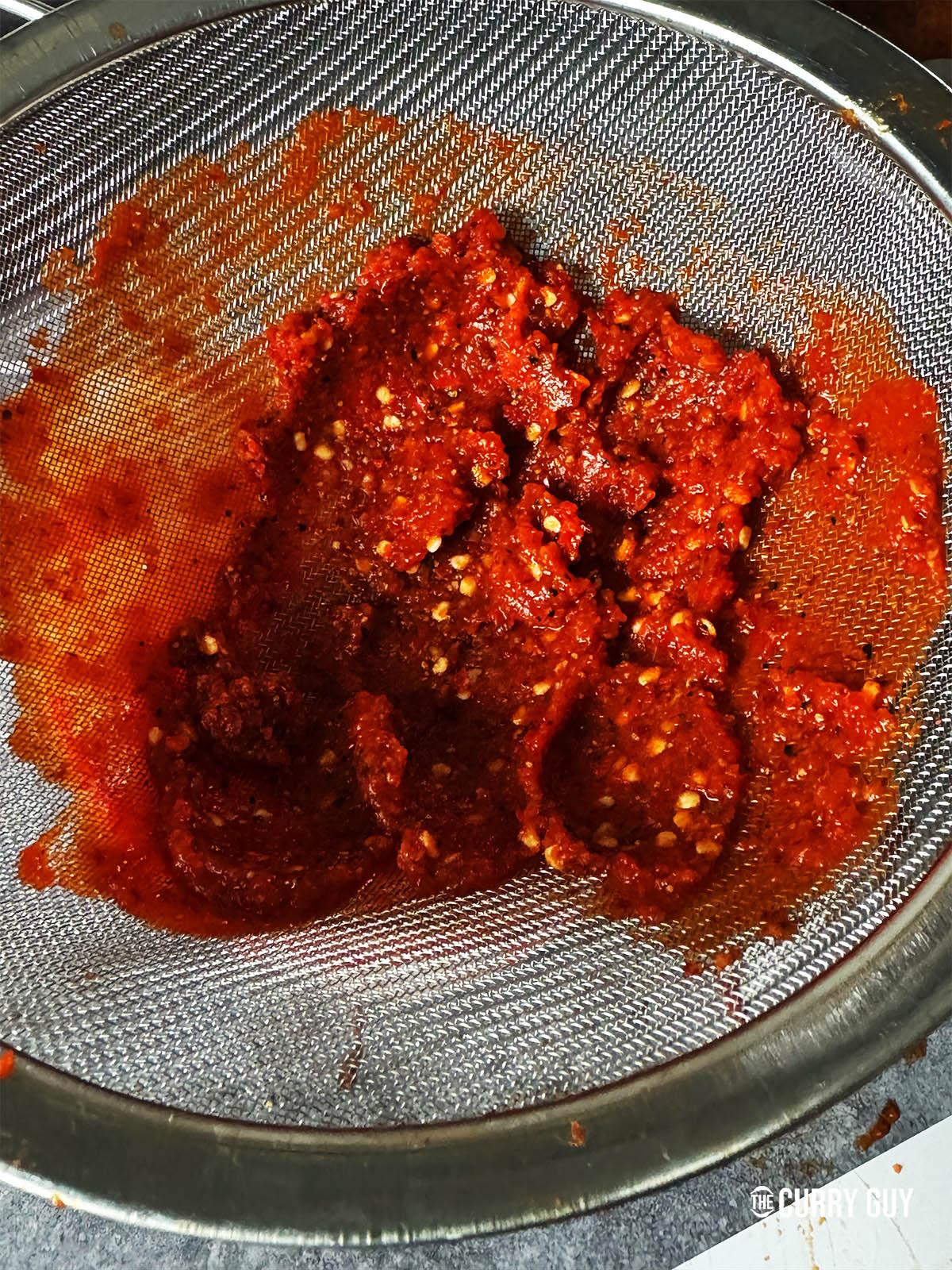 The remaining pepper paste after running the sauce through a sieve.