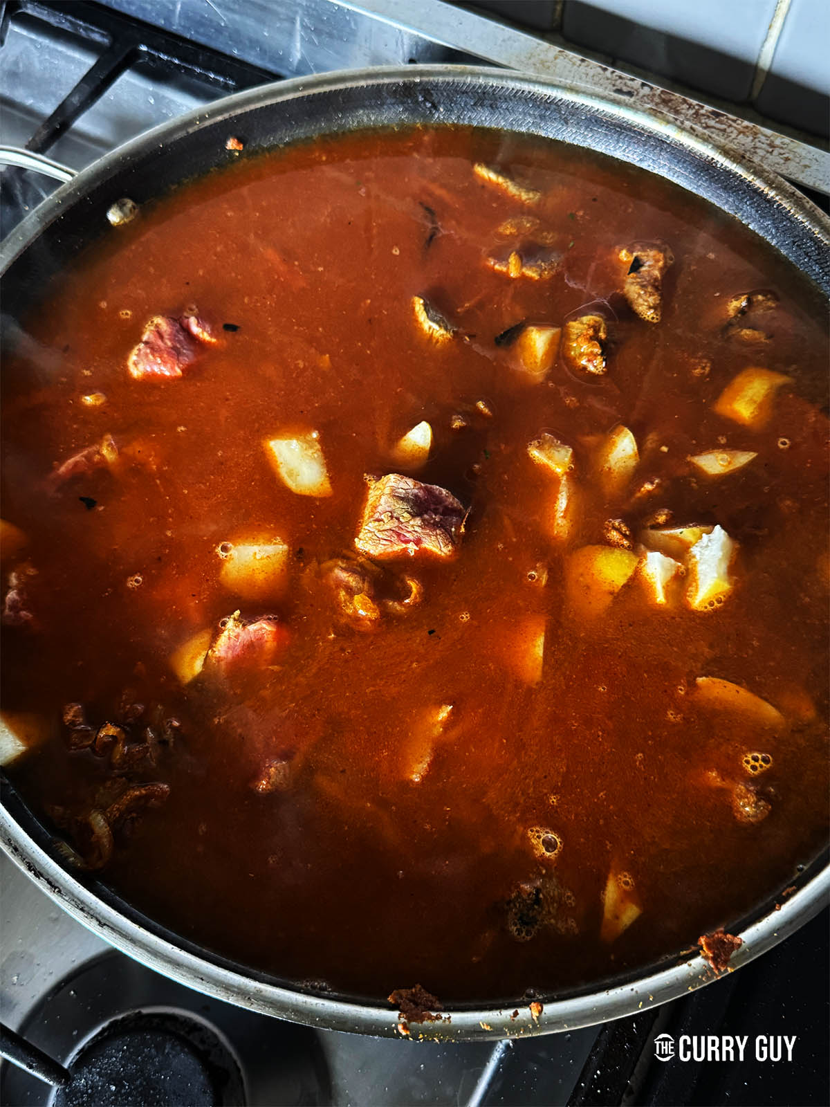 Adding water to stew the meat in. 