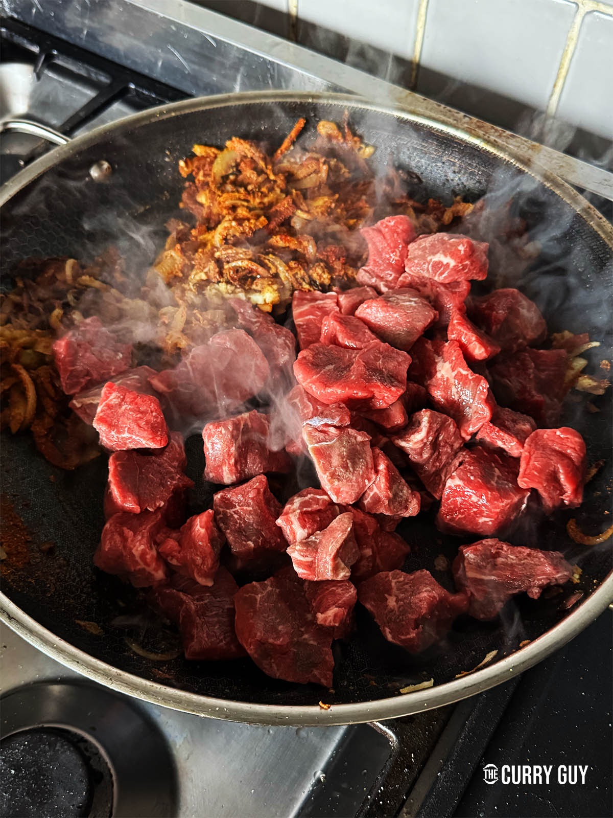 Adding the beef to the spice coated onions. 