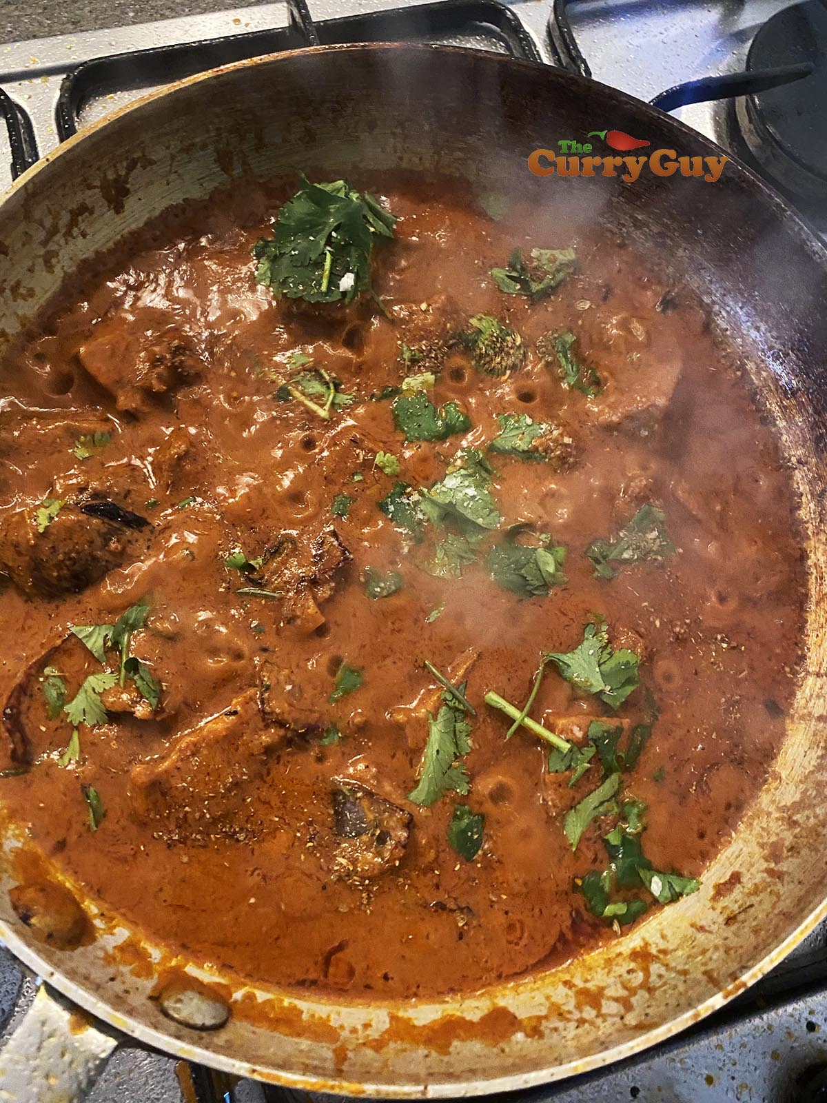 topping the curry with chopped coriander
