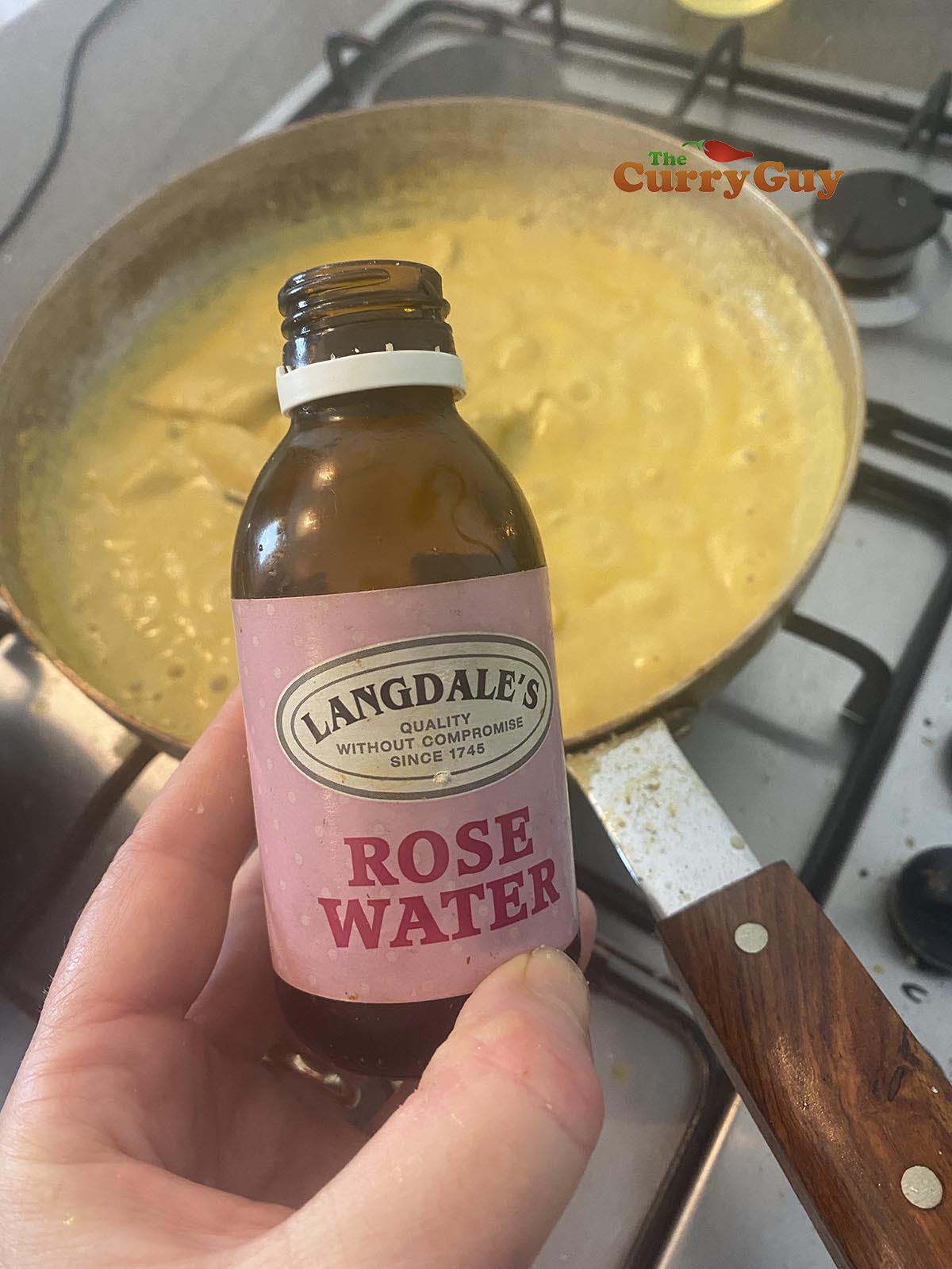 adding rose water to the chicken korma