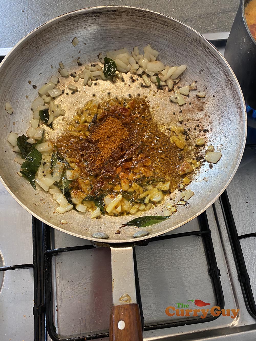 adding ground spices to the pan