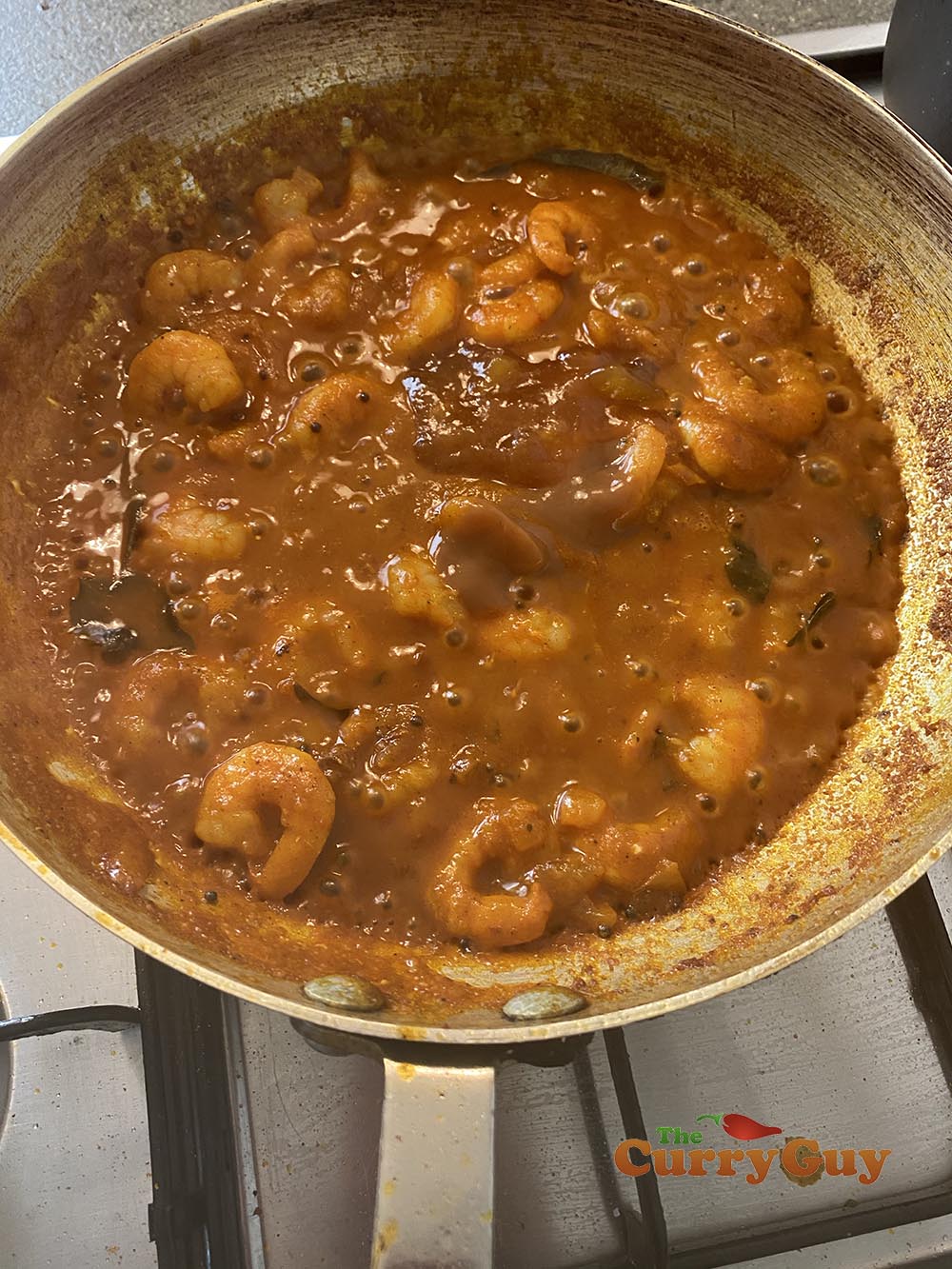 adding tamarind concentrate to the pan