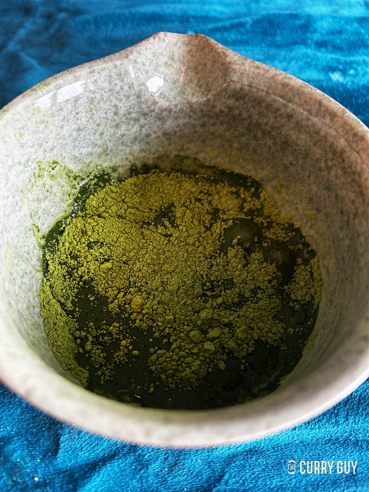 Adding two tablespoons water to whisk until smooth. 