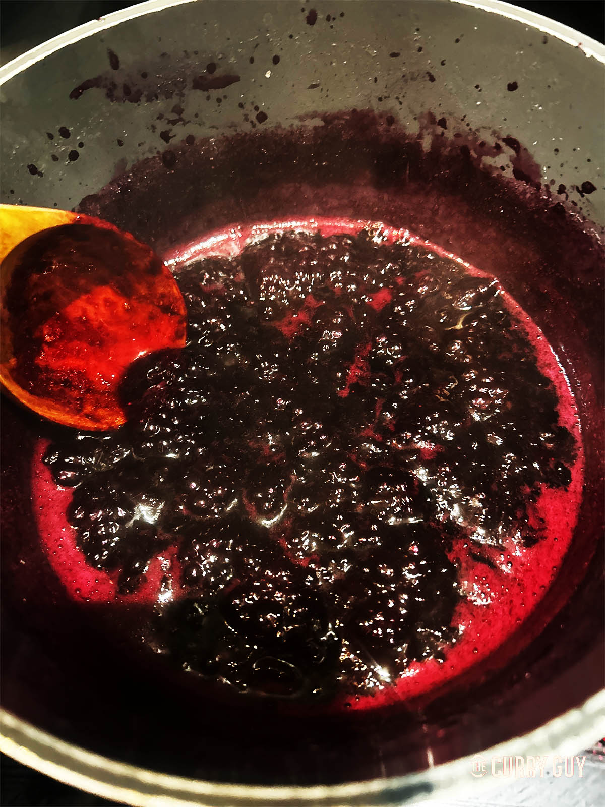 The finished blueberry syrup in a pot.