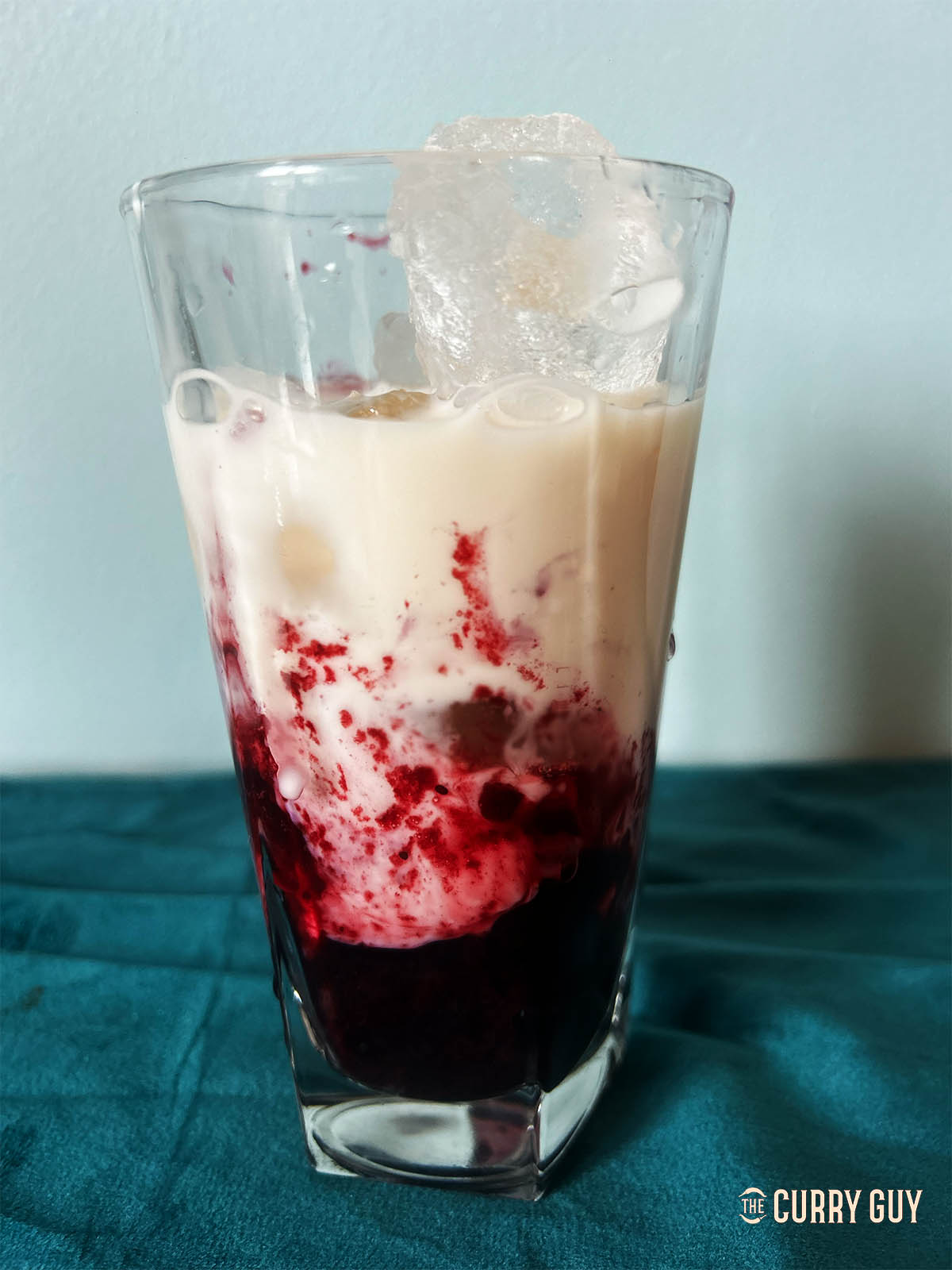 Adding the milk to the glass. 