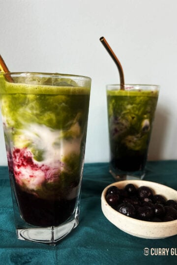 Adding the matcha over the blueberry syrup and milk.