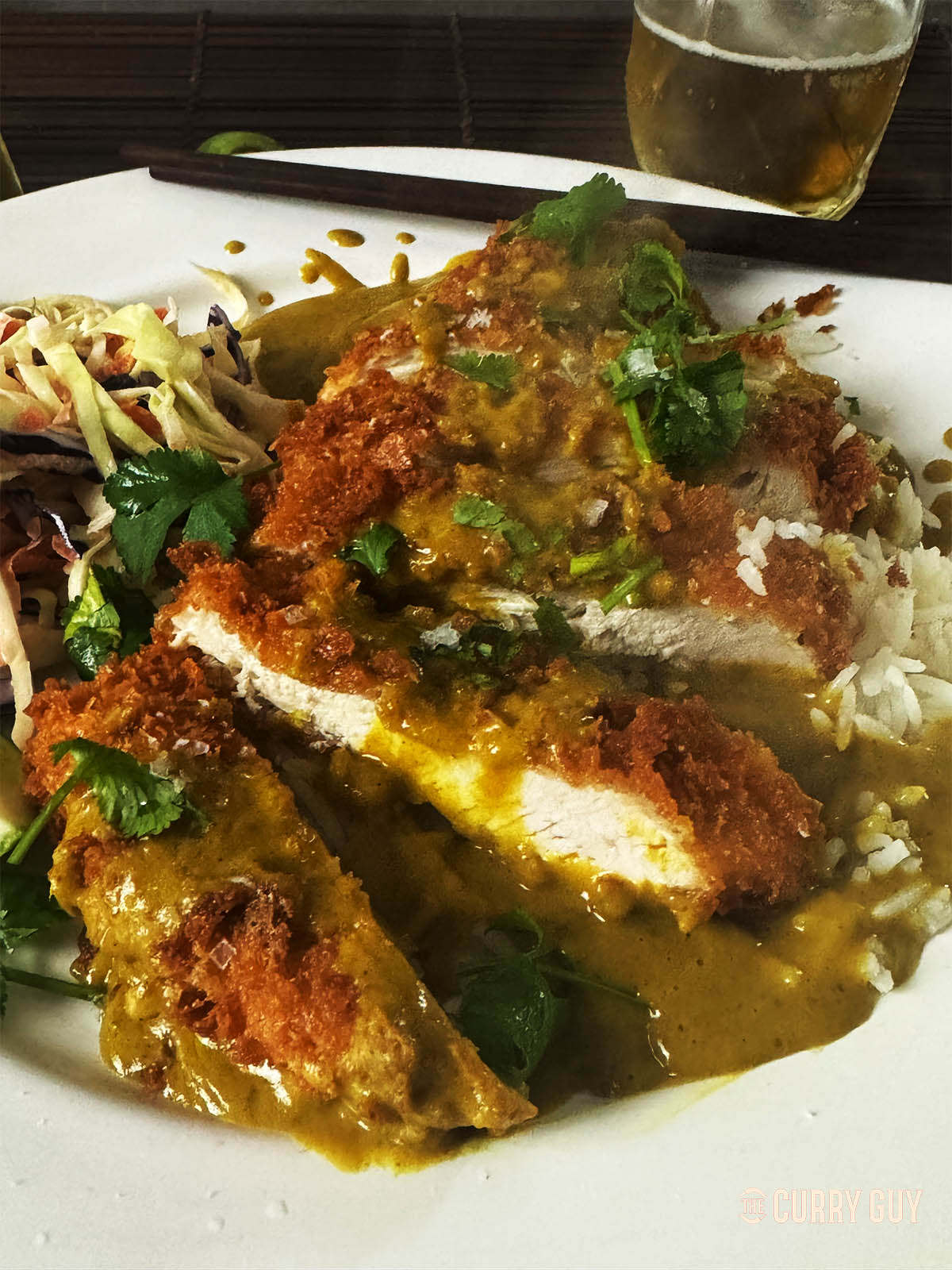 Chicken katsu curry on a serving plate. 