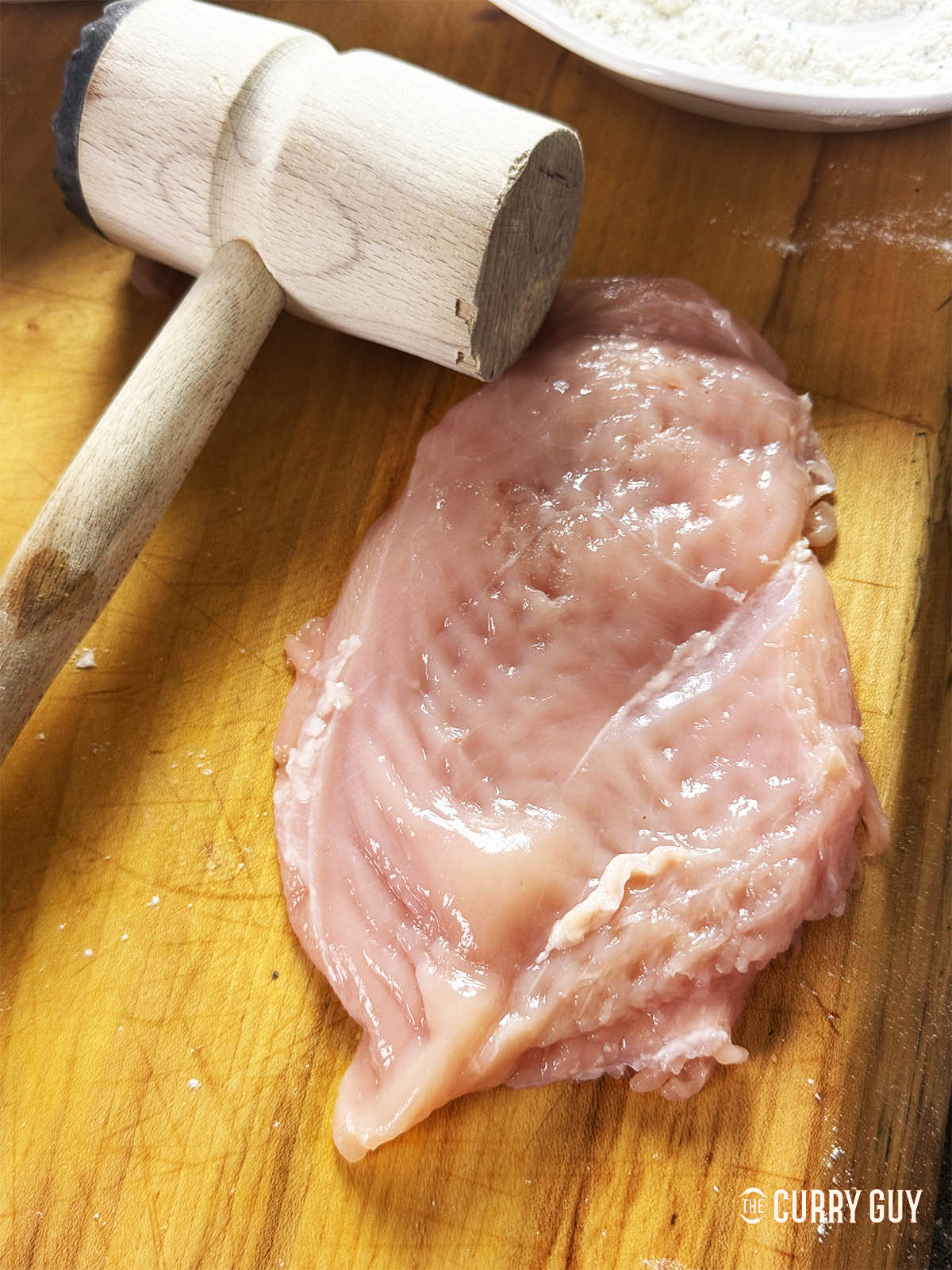 A chicken breast that has been pounded with a meat mallet. 