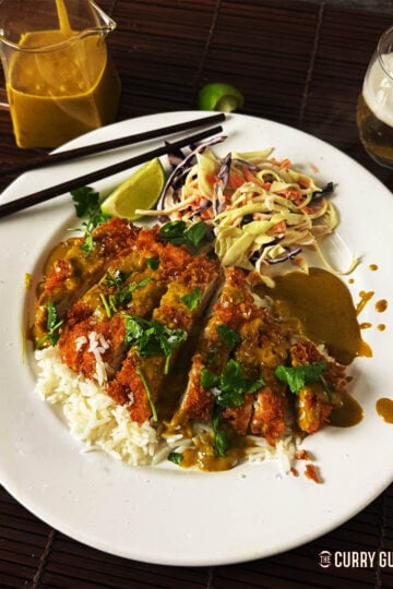 Chicken Katsu Curry on a bed of rice, served with Japanese coleslaw.