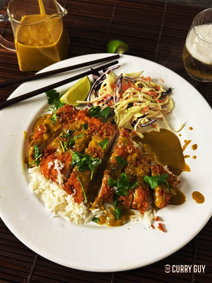 Chicken Katsu Curry on a bed of rice, served with Japanese coleslaw.