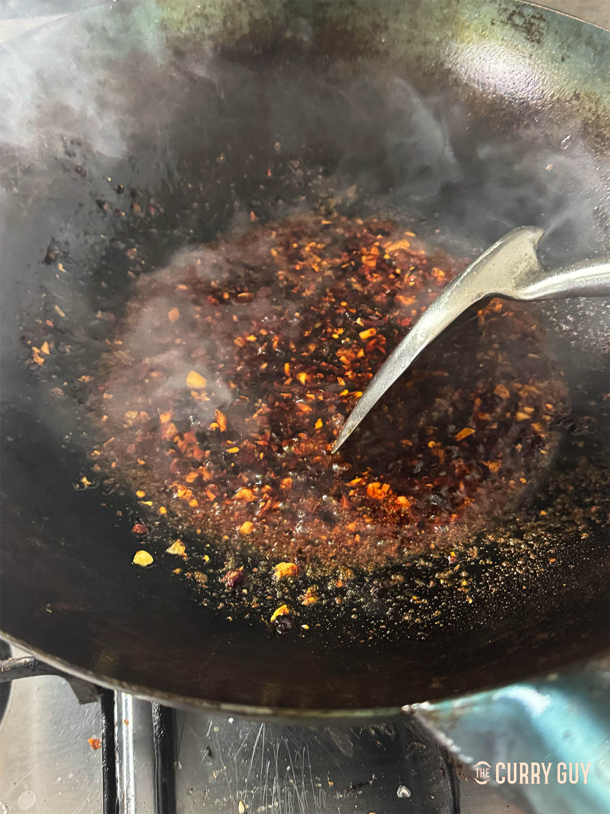 Stirring the sauce together and allowing it to simmer for a couple of minutes.