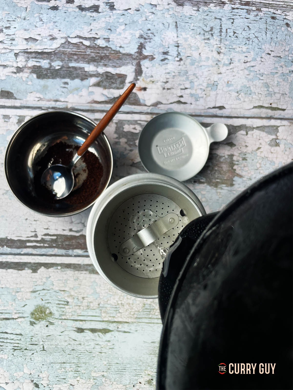 Pouring hot water over the coffee grounds in the filter.