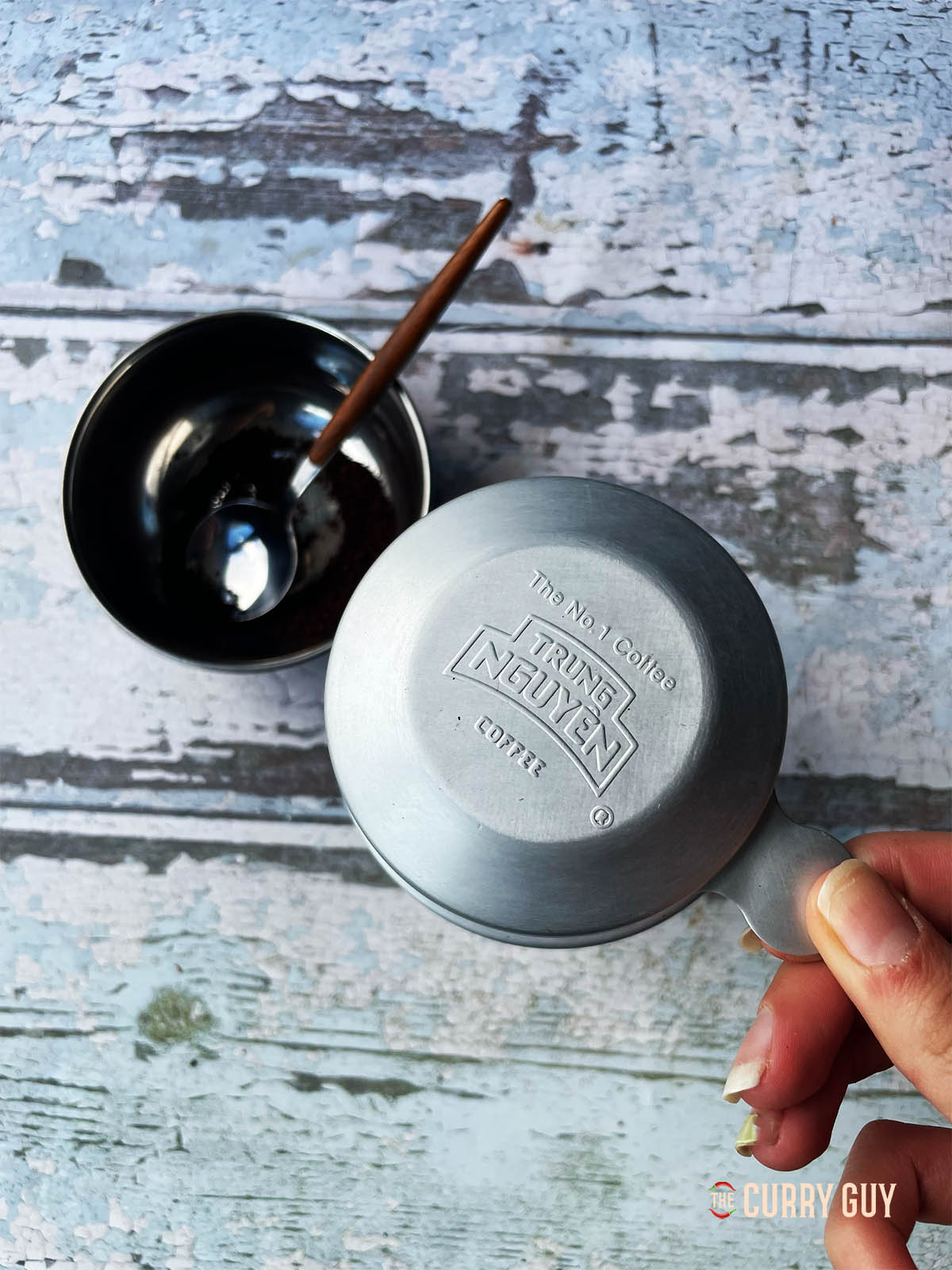 Covering the filter to allow the water to slowly pass through the coffee grounds.