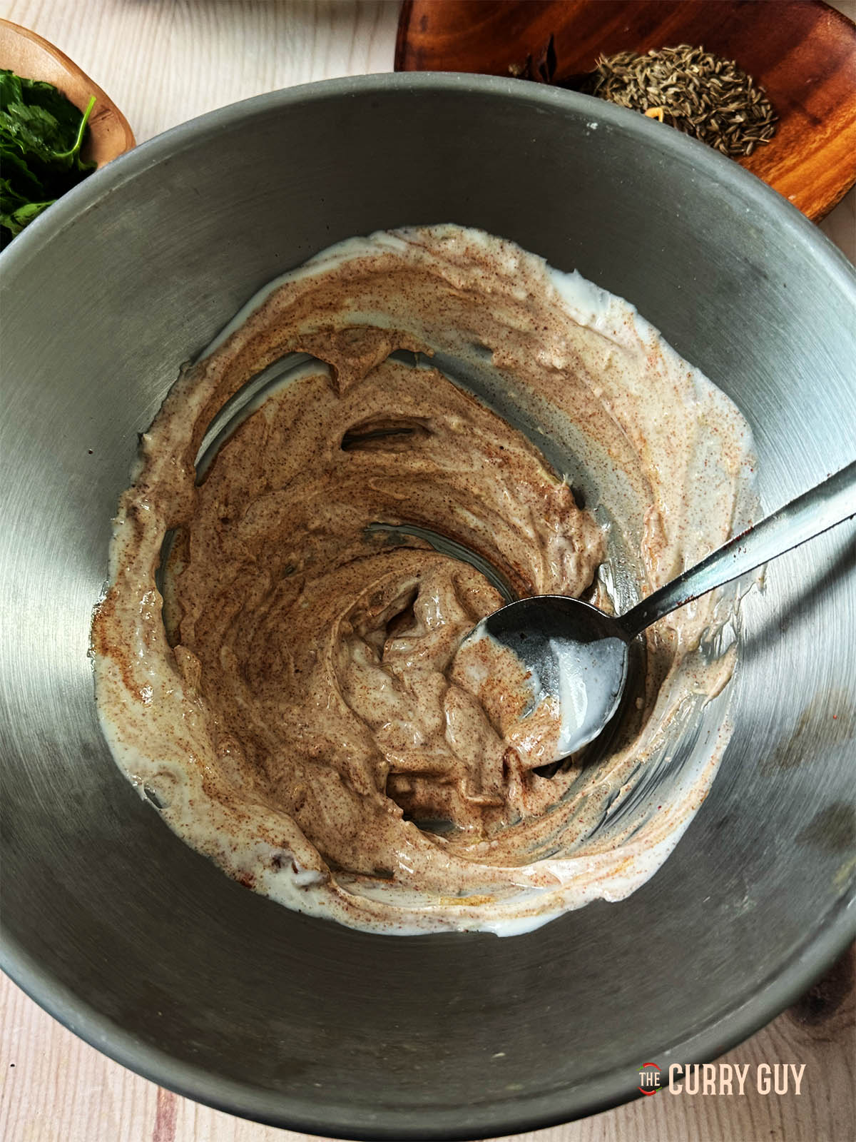 Whisking the yoghurt, paprika and ginger together in a bowl. 
