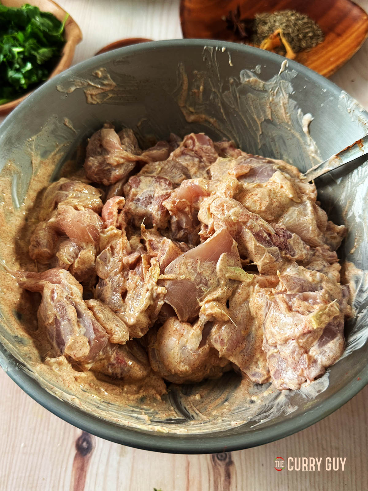 Adding the chicken to the marinade to marinate for a few minutes or overnight. 