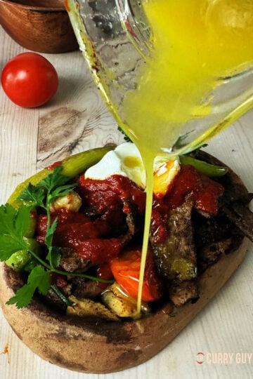 Pouring butter over an iskender kebab