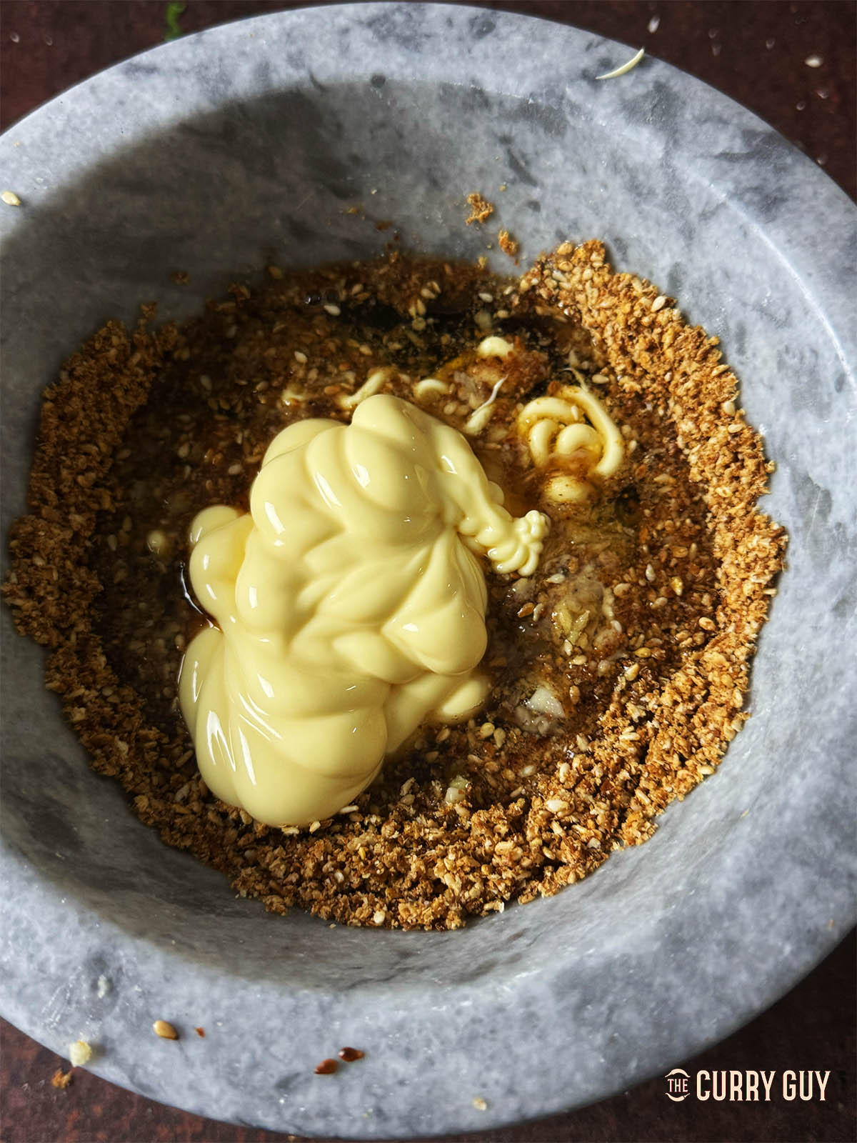 Adding the remaining ingredients to the sesame seeds.