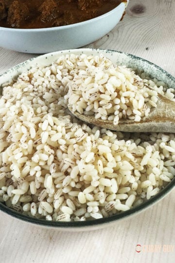 Matta rice on a spoon in a serving bowl.