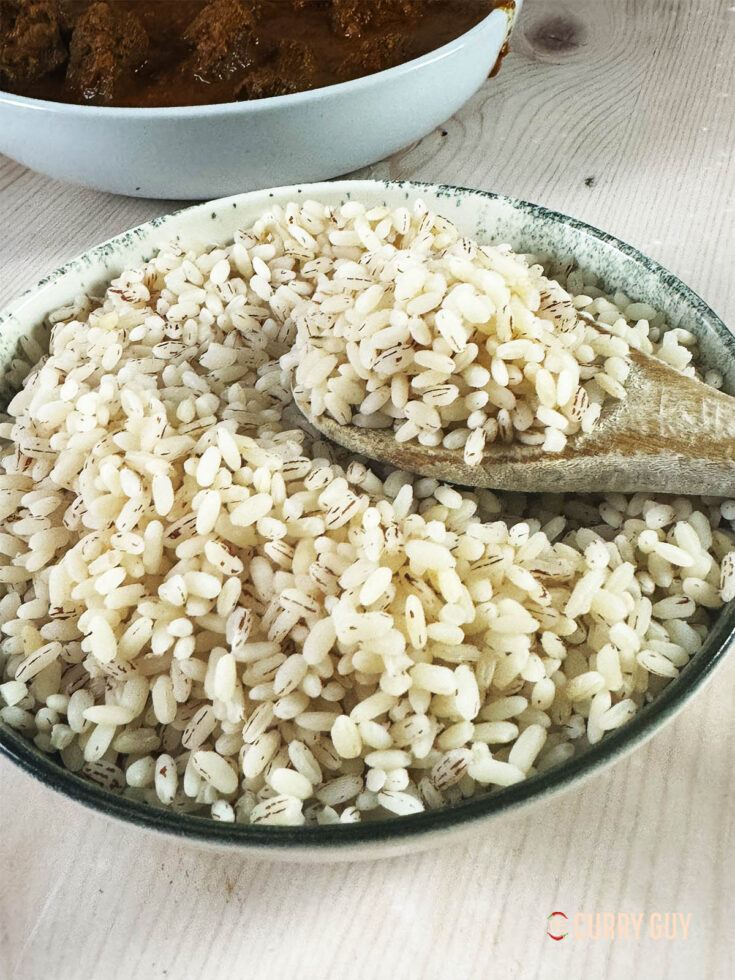 Matta rice on a spoon in a serving bowl.