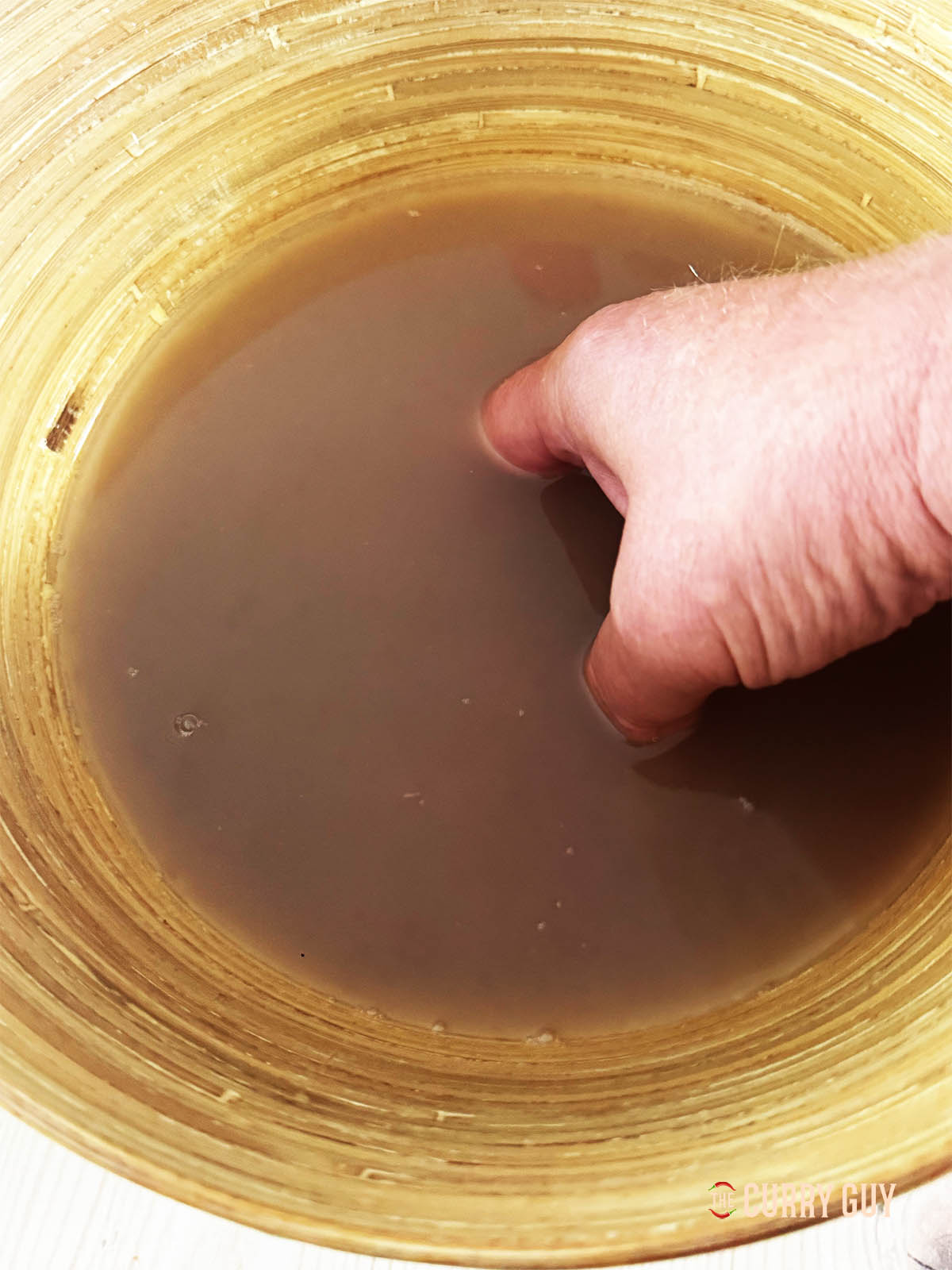 Washing the starch off the Matta rice grains.