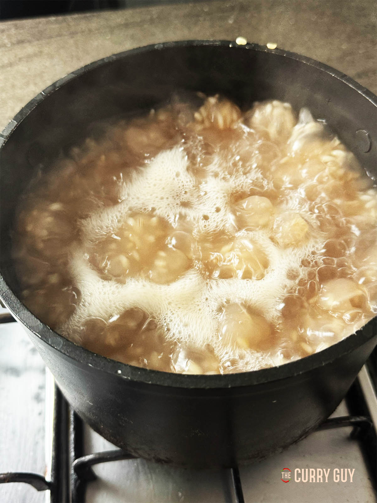 Boiling the Matta rice in a large pot.