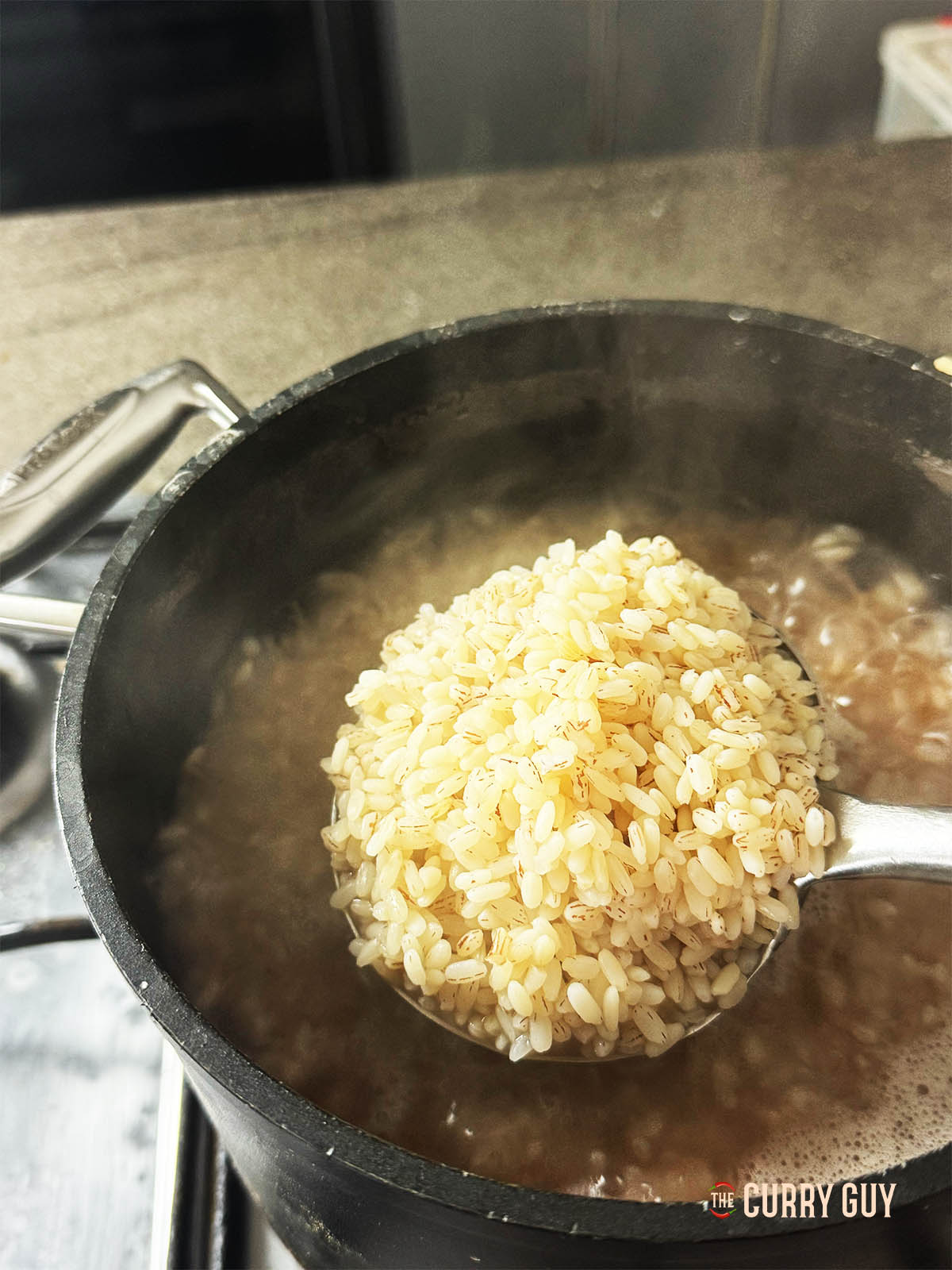 Showing the cooked rice on a spoon.