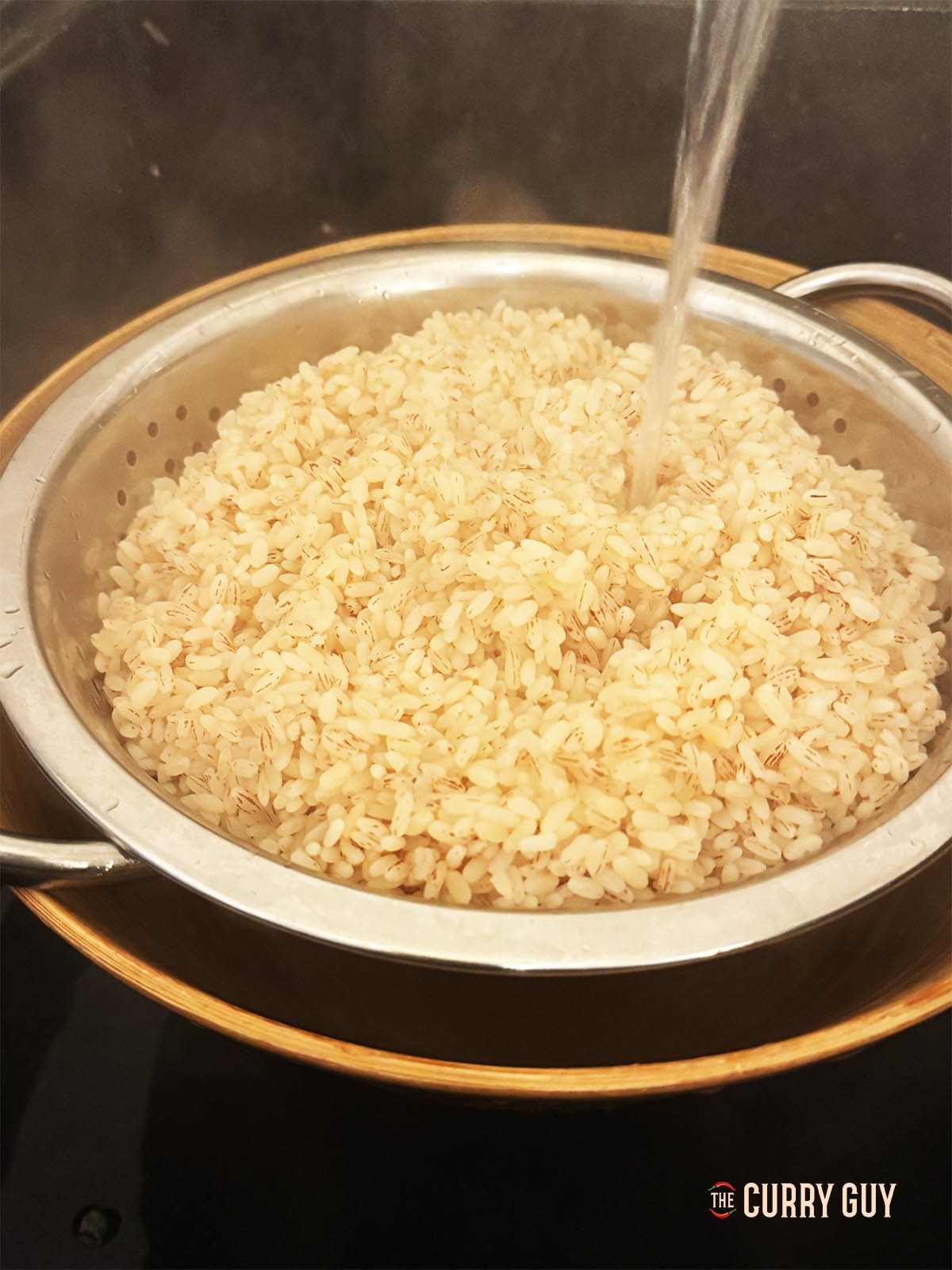 Straining the rice and running water over it.