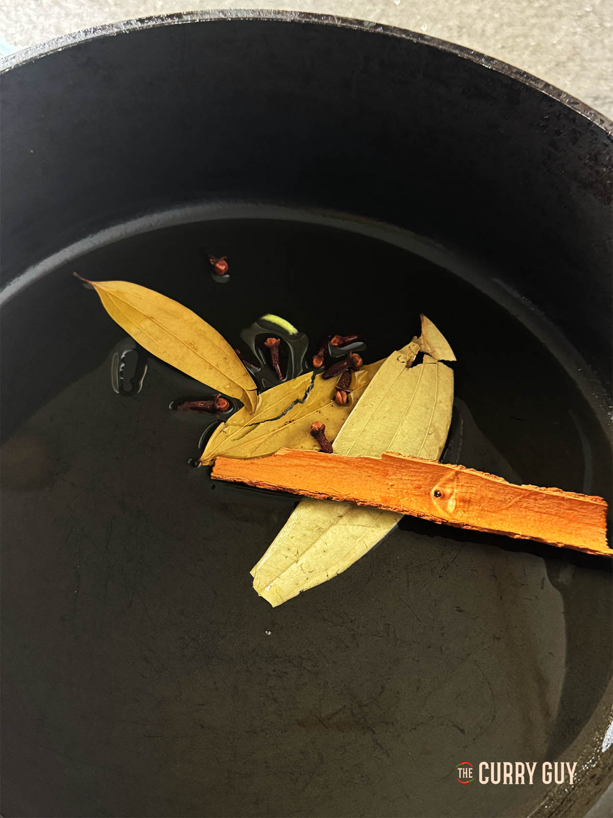 Infusing the cinnamon, cloves, bay leaves in hot butter.