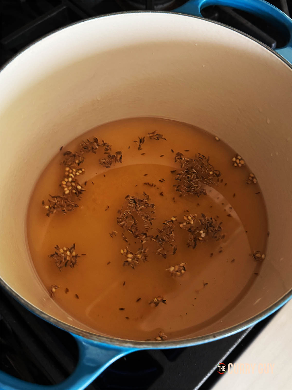 The spices, sugar, salt, vinegar and water in a pot coming to a simmer.