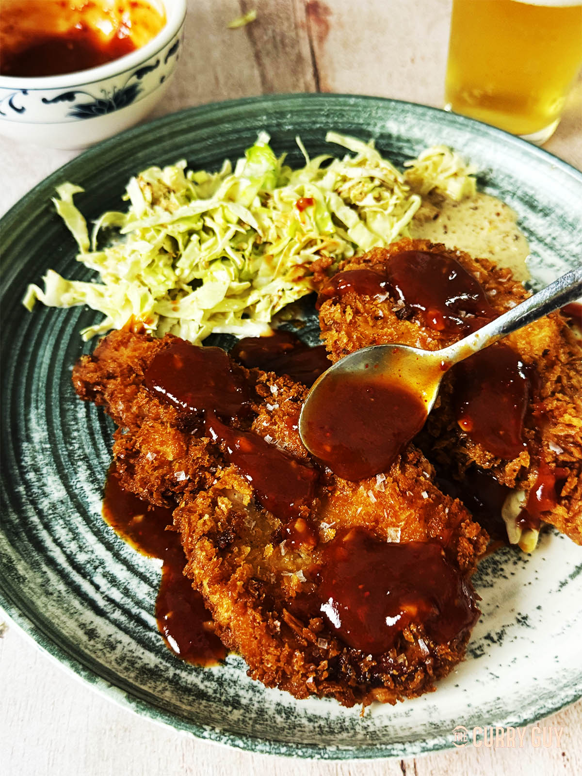 Tonkatsu on a plate with Japanese coleslaw.