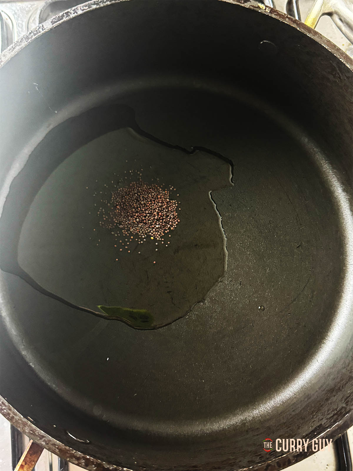 Infusing the mustard seeds into the oil over a high heat.