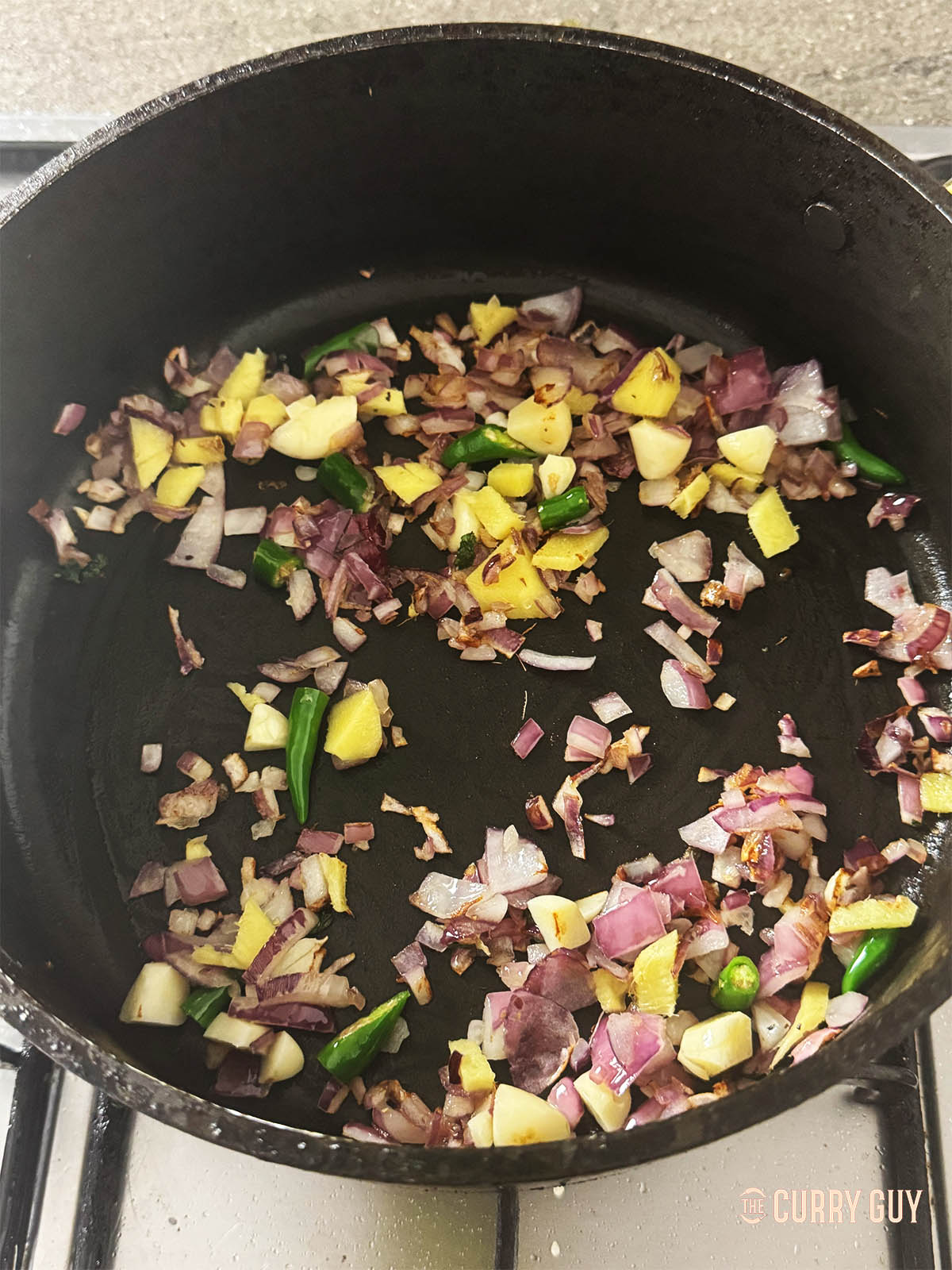 Frying the onion, garlic and ginger until soft.
