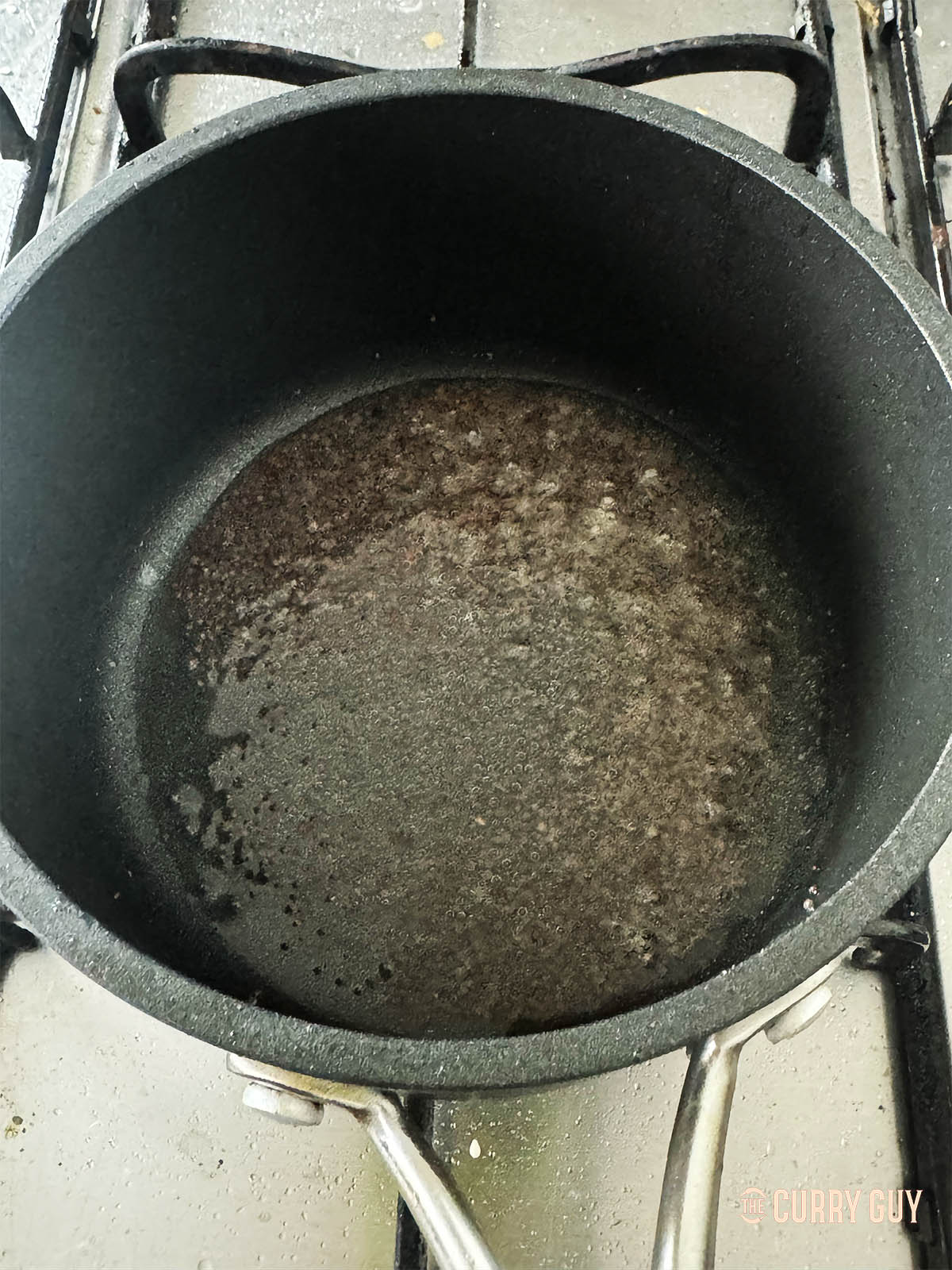 Frying the mustard seeds to infuse their flavour into the coconut oil. 
