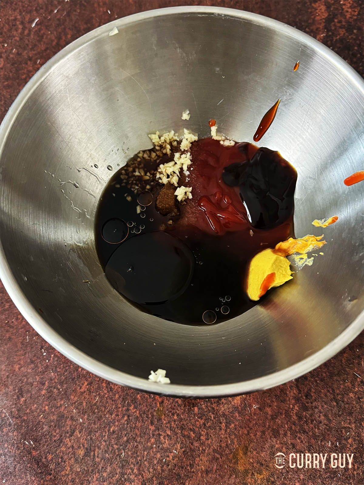 Placing the ingredients for the sauce in a mixing bowl. 
