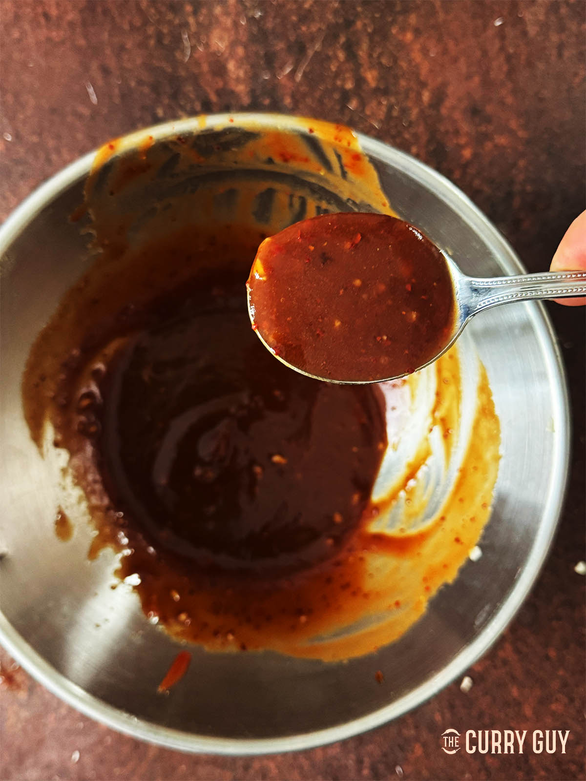 A spoonful of the sauce for tasting. 
