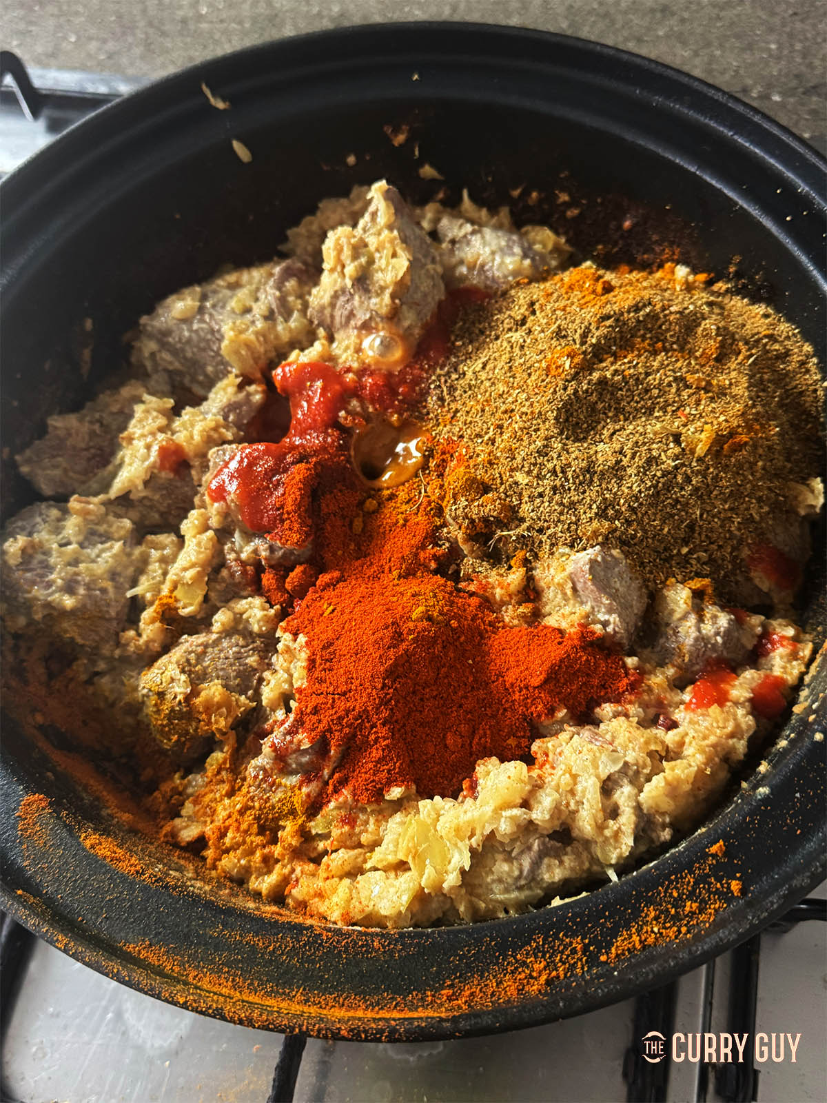 Adding the garlic and ginger paste along with the ground spices and paprika.