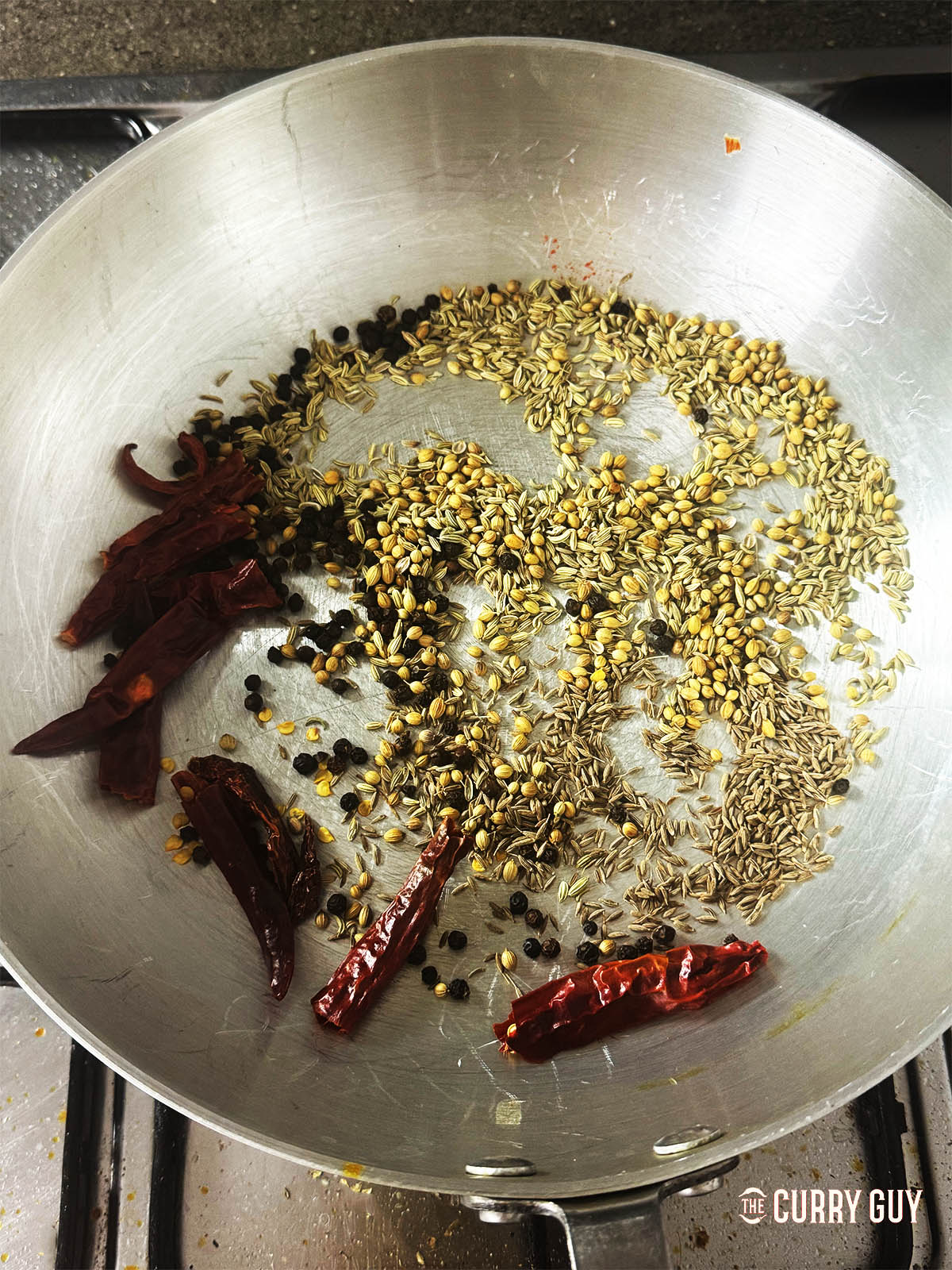 Toasting the spices for the spice powder in a pan.