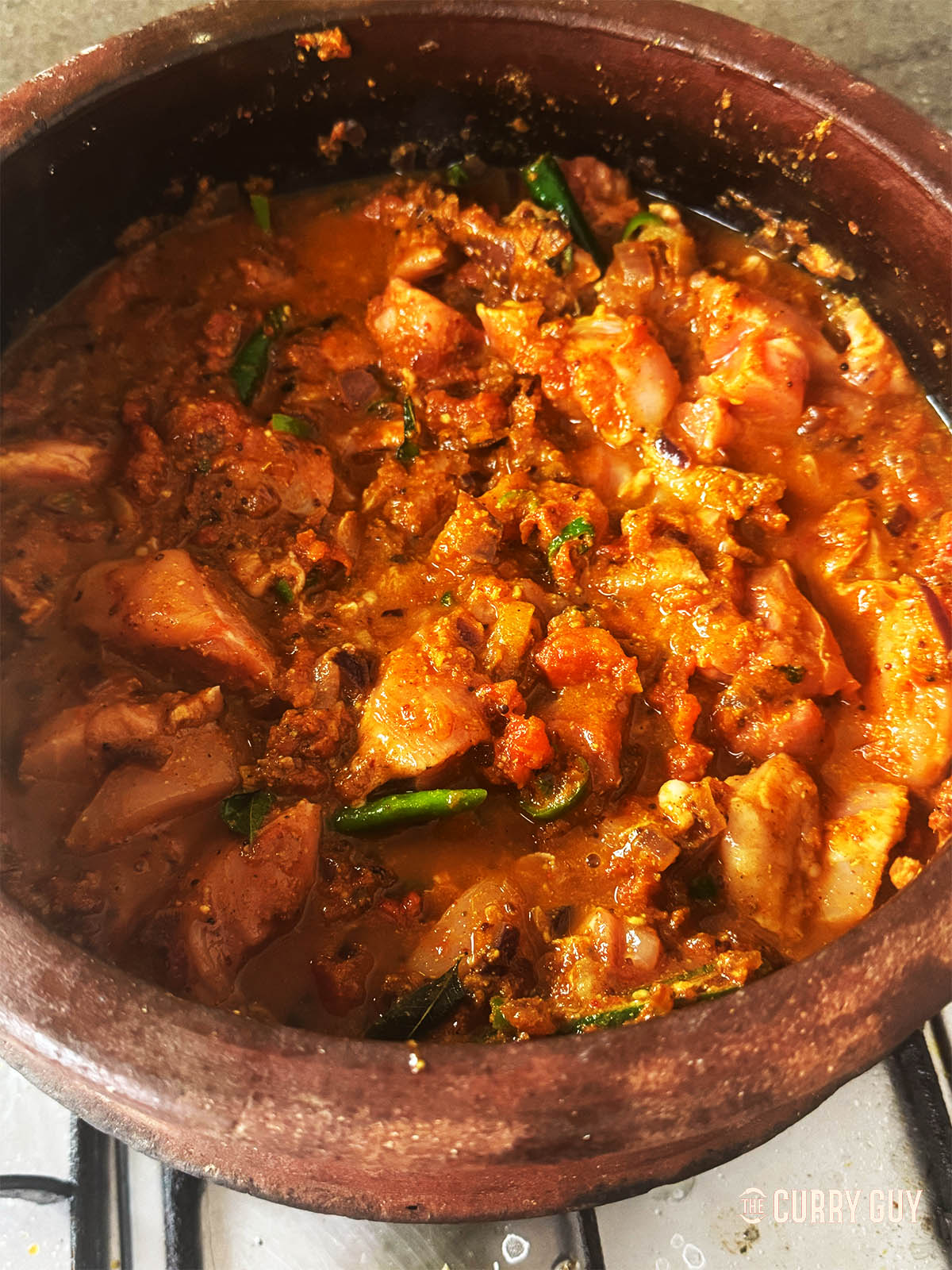 Stirring the chicken into the pan.