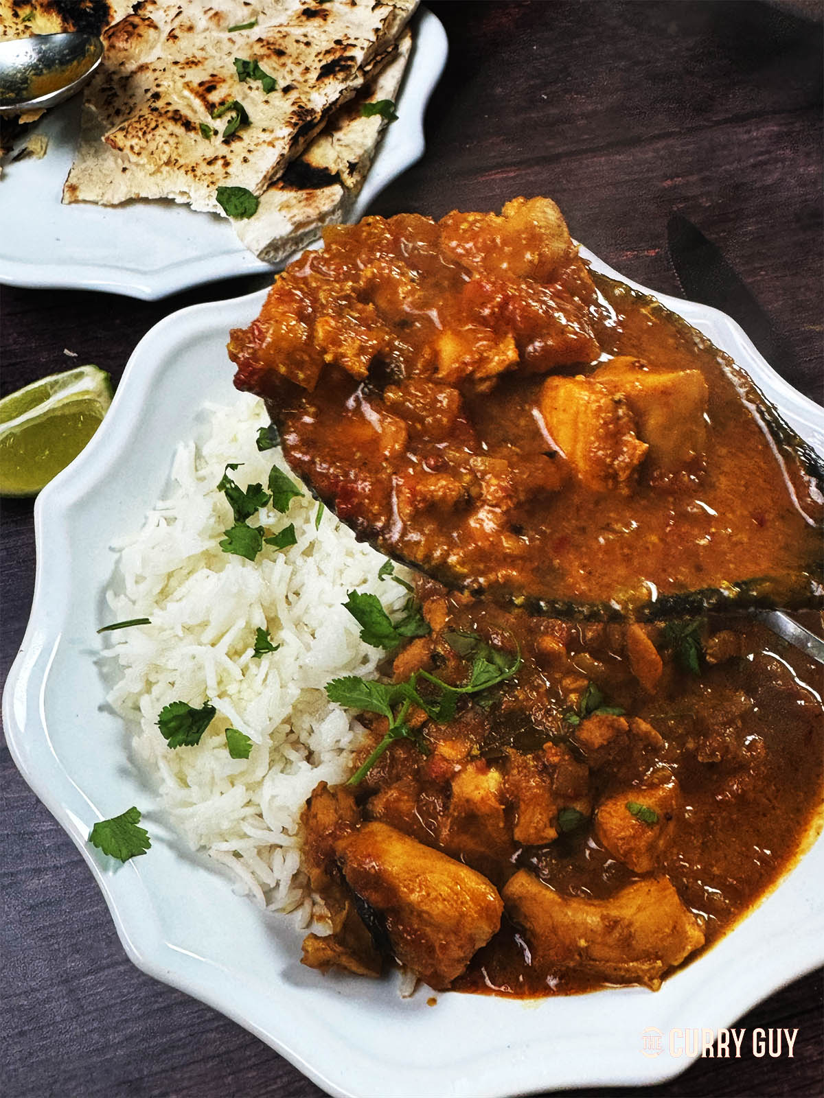 Chennai Chicken curry being served over rice.